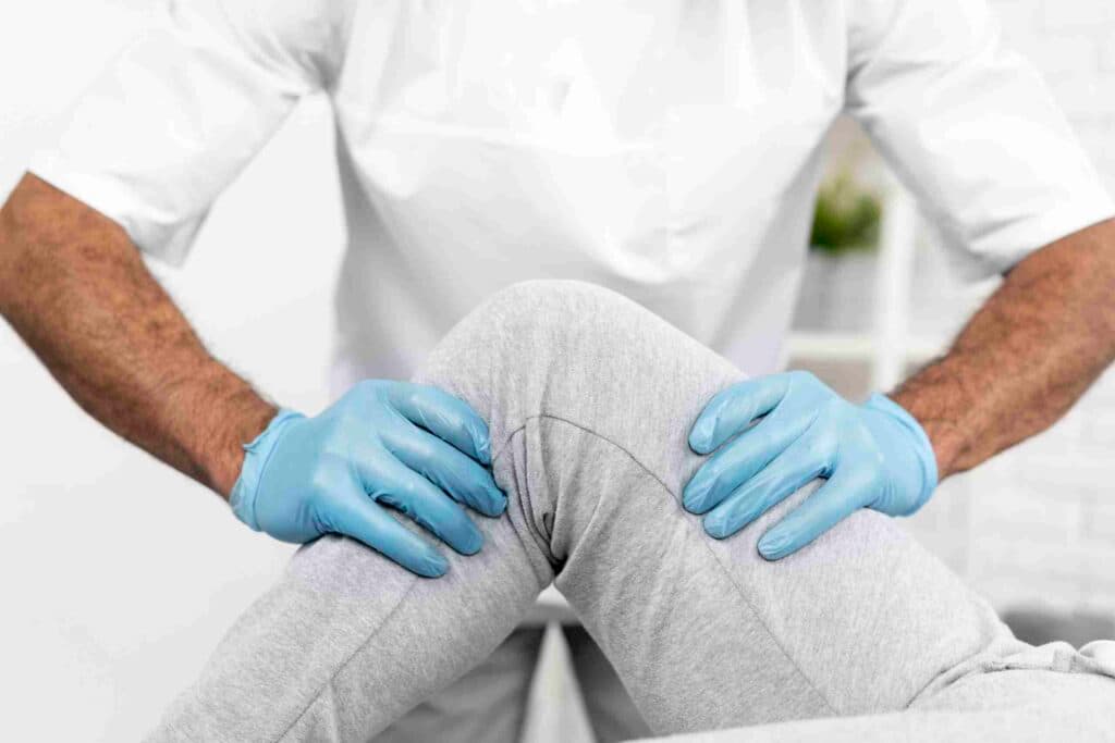 male physiotherapist checking woman's knee mobility