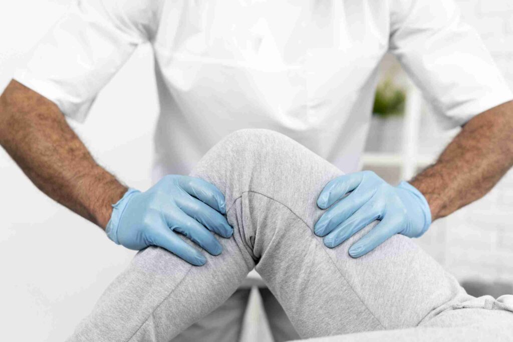 male physiotherapist checking woman's knee mobility